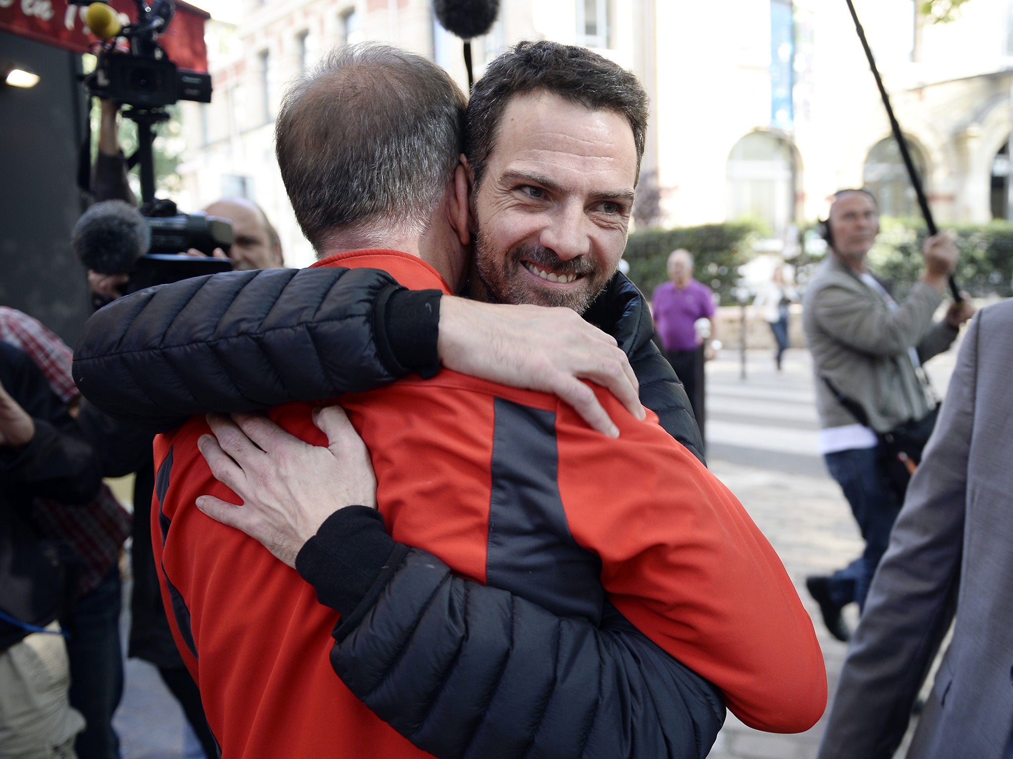 Jérôme Kerviel hugs a member of his support committee after he left jail near Paris
