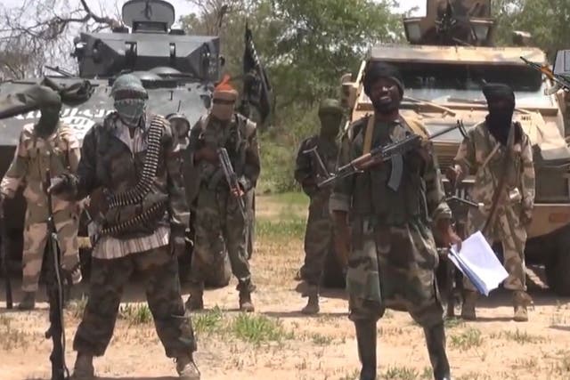 The leader of Boko Haram, Abubakar Shekau (with papers) in a video grab taken in July