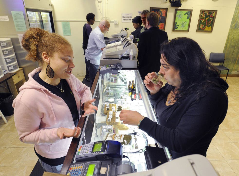 Patient Sara Romano, right, selects some medical marijuana at the Berkeley Patients Group clinic in California