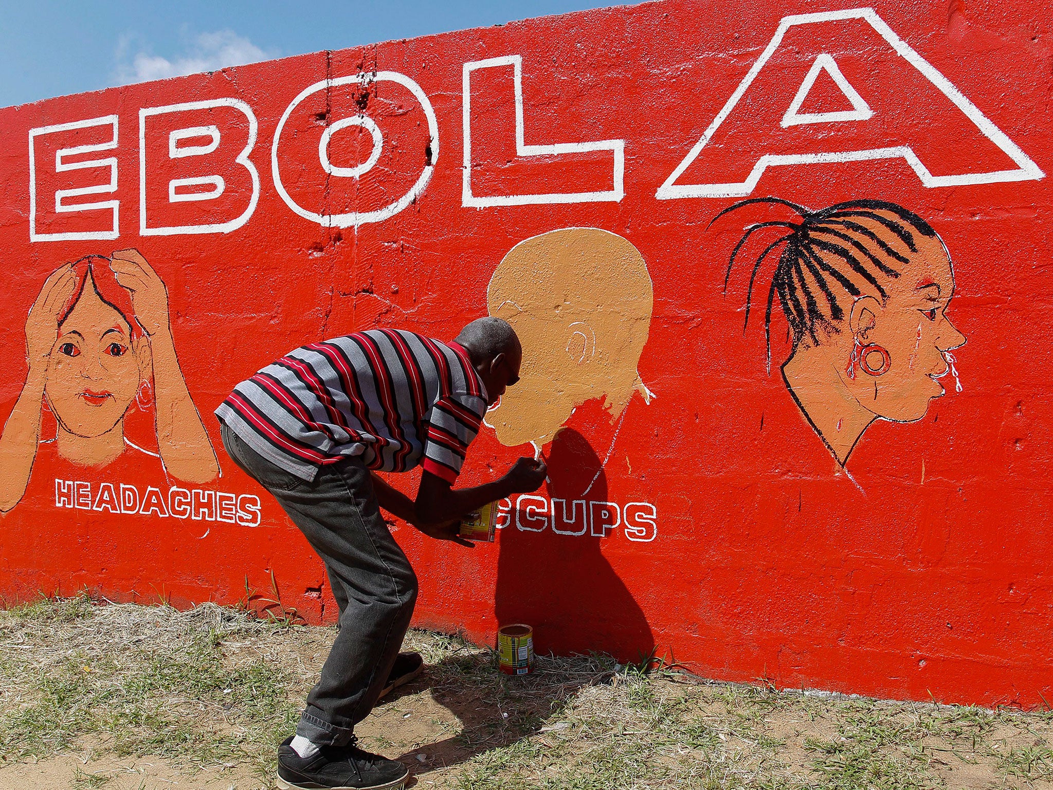 A Liberian man paints on a wall as part of a sensitization programme about the deadly Ebola virus in Monrovia, Liberia. The World Health Organization (WHO) has said the number of deaths from Ebola has risen to 2100 in West Africa with an exponential surge