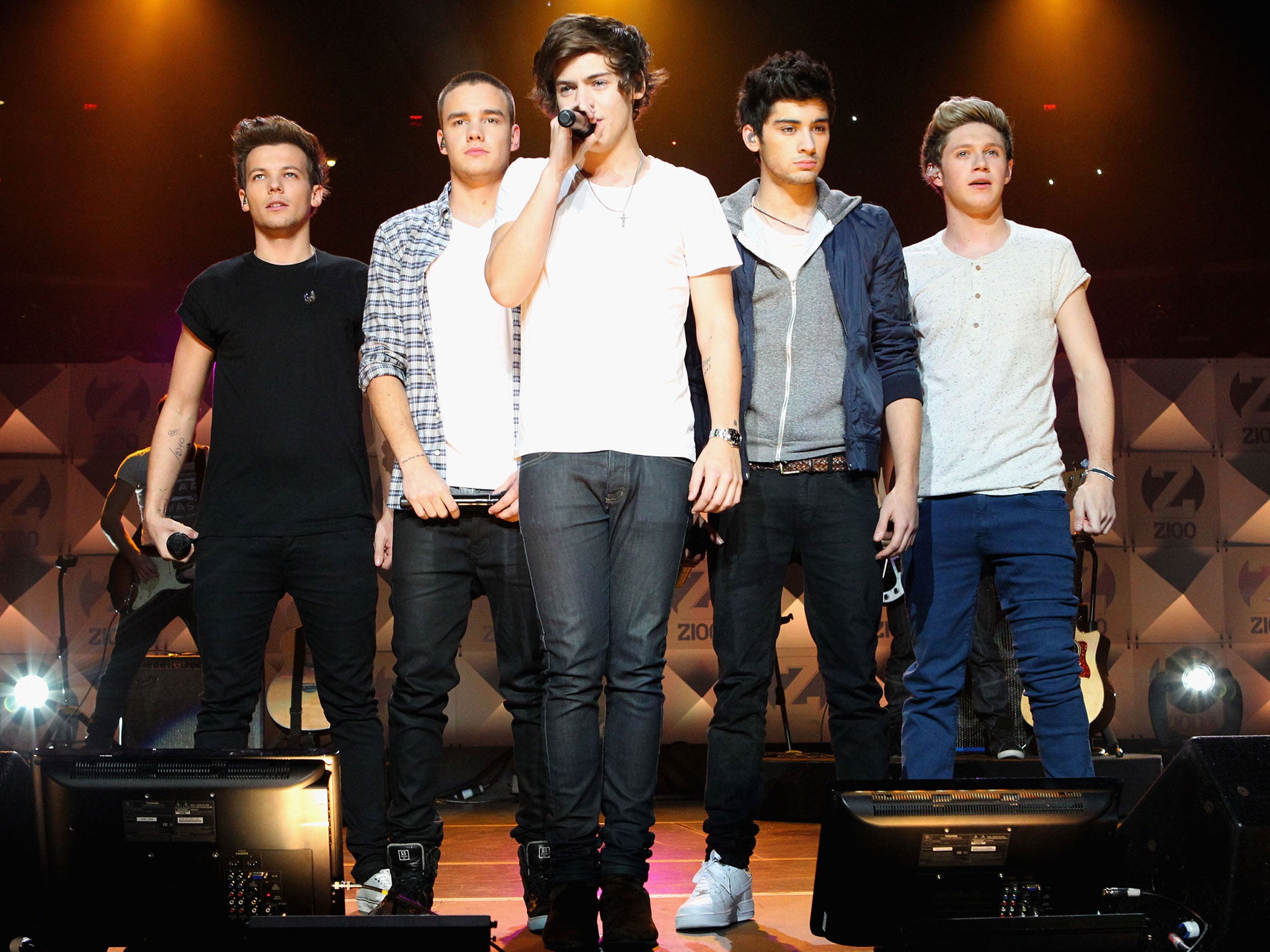 Louis Tomlinson, Liam Payne, Harry Styles, Zayn Malik and Niall Horan of One Direction on stage
