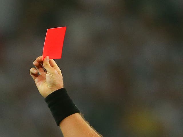 <p>A referee issues a red card</p>
