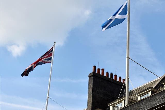The Scottish flag flutters next to the Union flag over Downing Street in London
