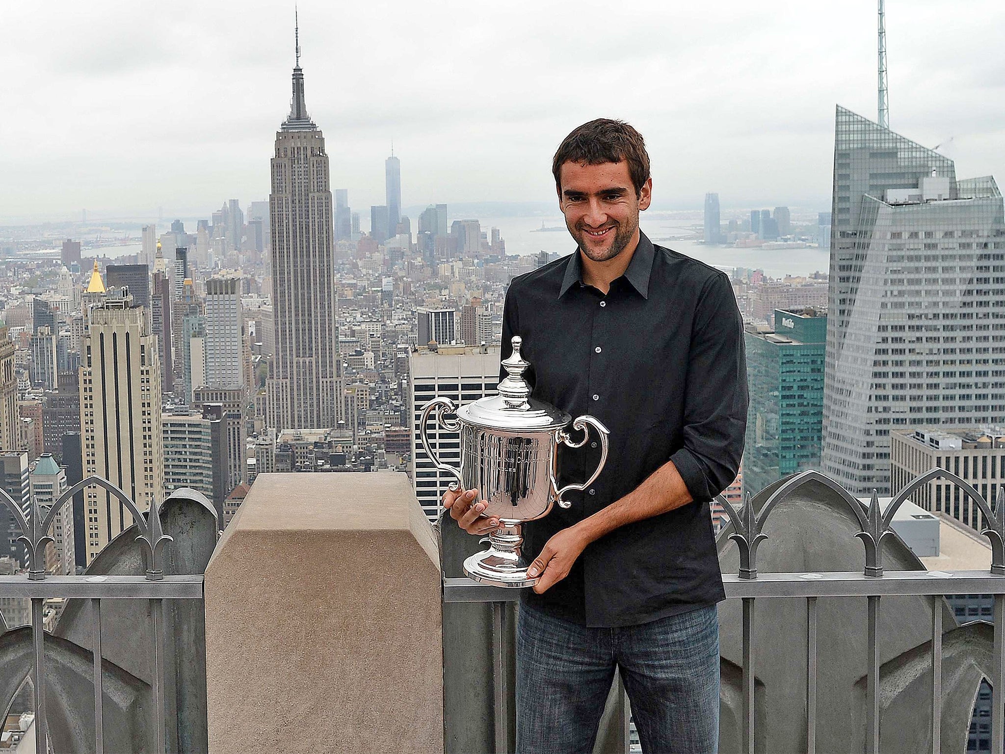 Marin Cilic shows off the US Open men’s trophy at the top of the Rockefeller Centre in New York 