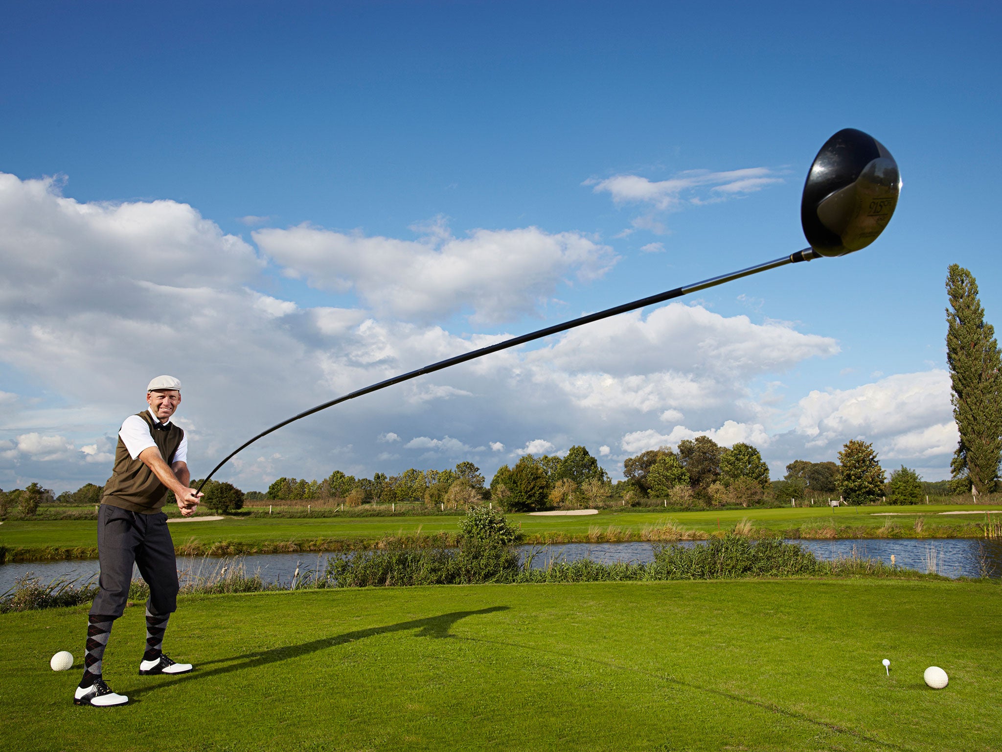 Karsten Maas in Germany takes a swing with the longest usable golf club at 14ft 5in.