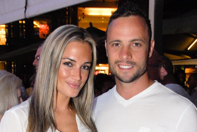  A picture taken on January 26, 2013 shows Olympian sprinter Oscar Pistorius posing next to his girlfriend Reeva Steenkamp at Melrose Arch in Johannesburg.