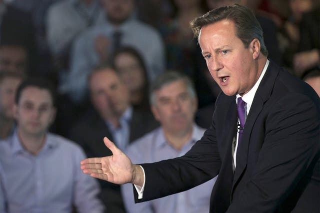 British Prime Minister David Cameron gestures as he speaks during a visit to Scottish Widows offices in Edinburgh