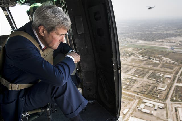 United States Secretary of State John Kerry looks out over Baghdad from a helicopter delivering him to a meeting with the newly appointed Iraqi government