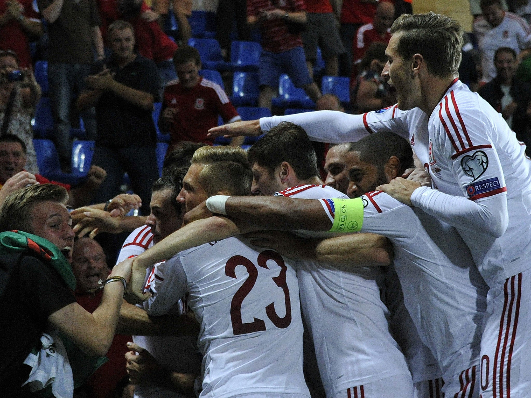 Wales players celebrate Gareth Bale's goal against Andorra as fans run onto the pitch