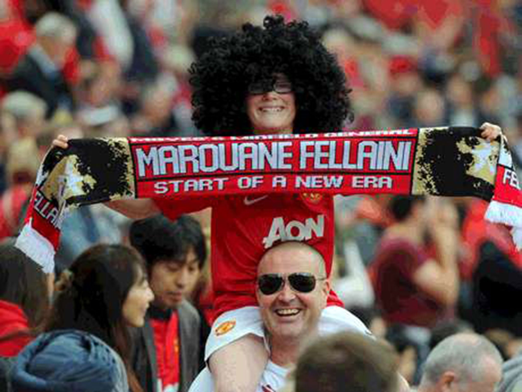 A young Manchester United fan shows his support for Marouane Fellaini