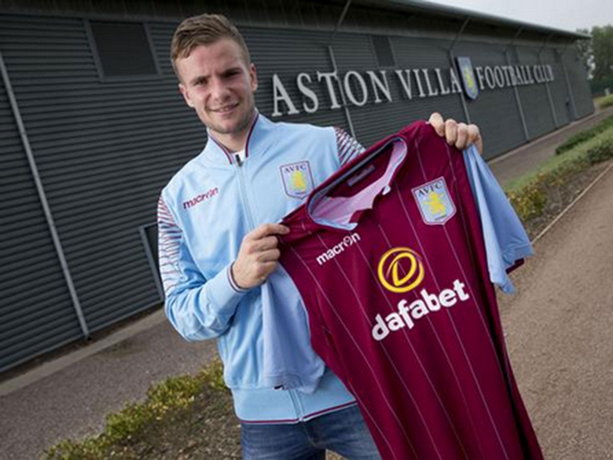Tom Cleverley holds his new Aston Villa shirt after signing for the club on loan