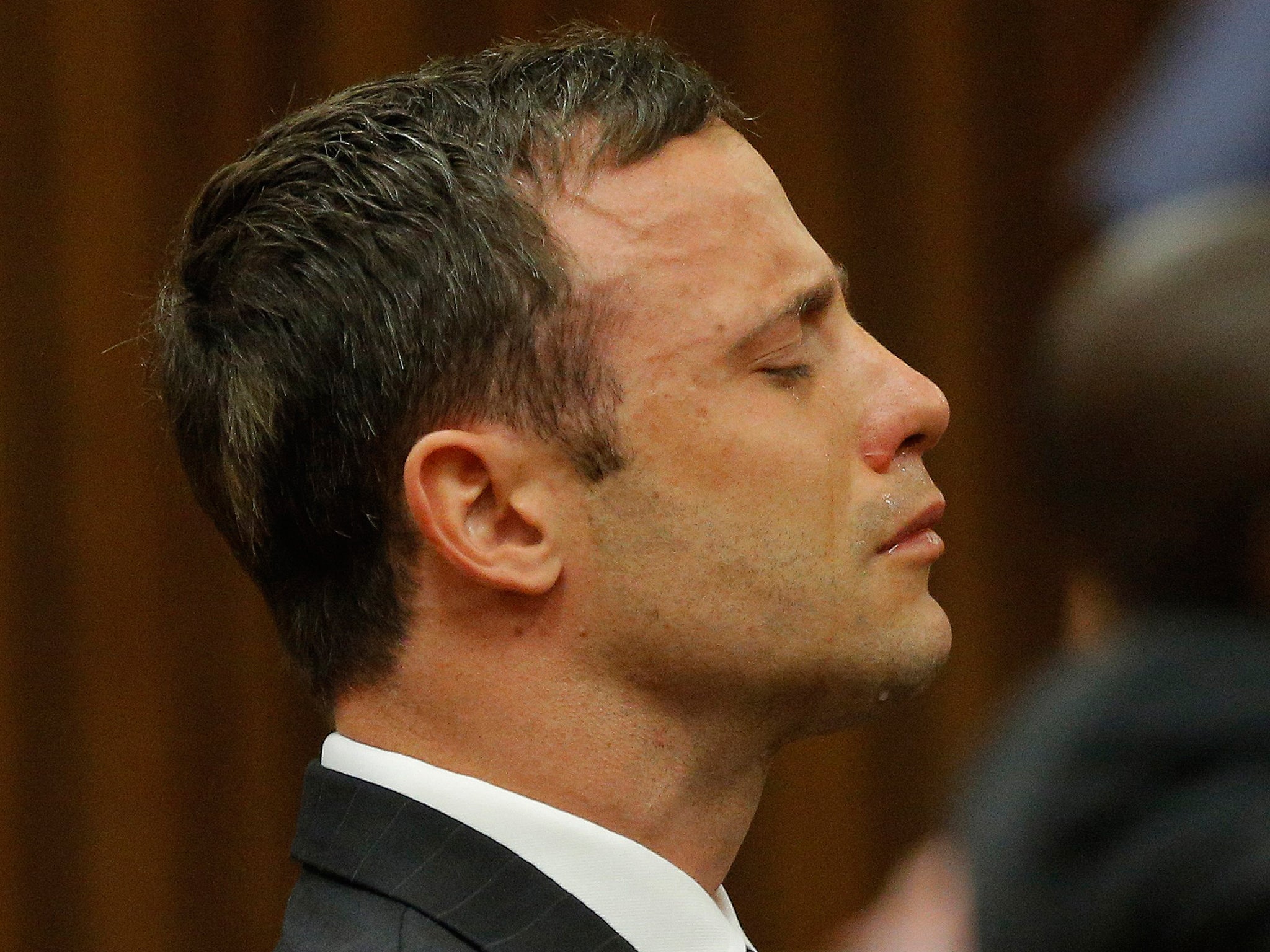 Oscar Pistorius reacts as he listens to Judge Thokozile Masipa's judgement at the North Gauteng High Court in Pretoria