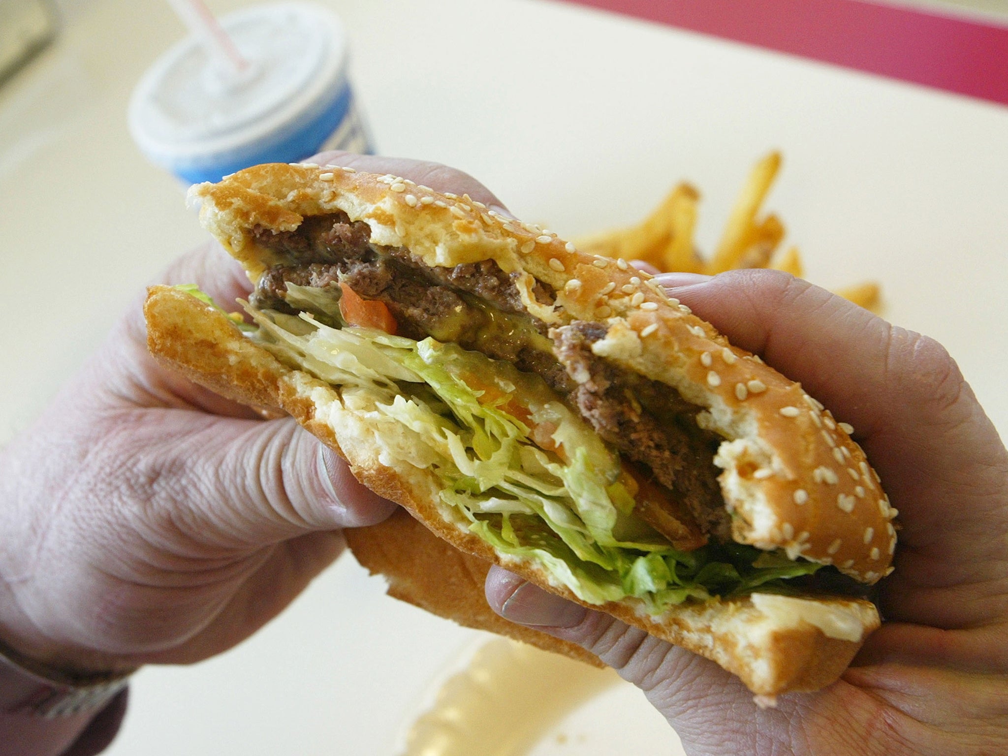 A first-person view of someone eating a hamburger