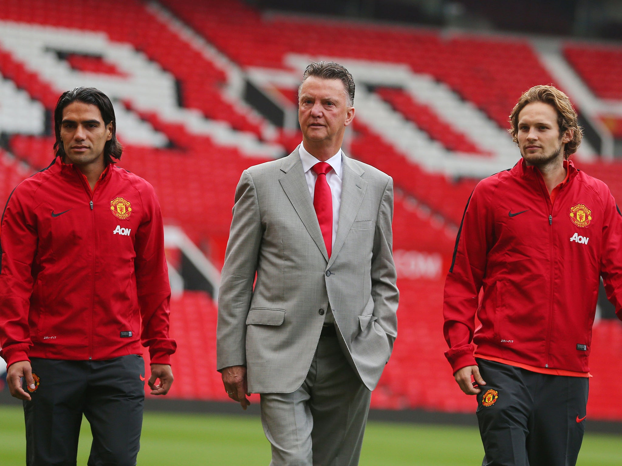 Manchester United manager Louis van Gaal (centre) with his new signings Radamel Falcao (left) and Daley Blind during a photocall at Old Trafford