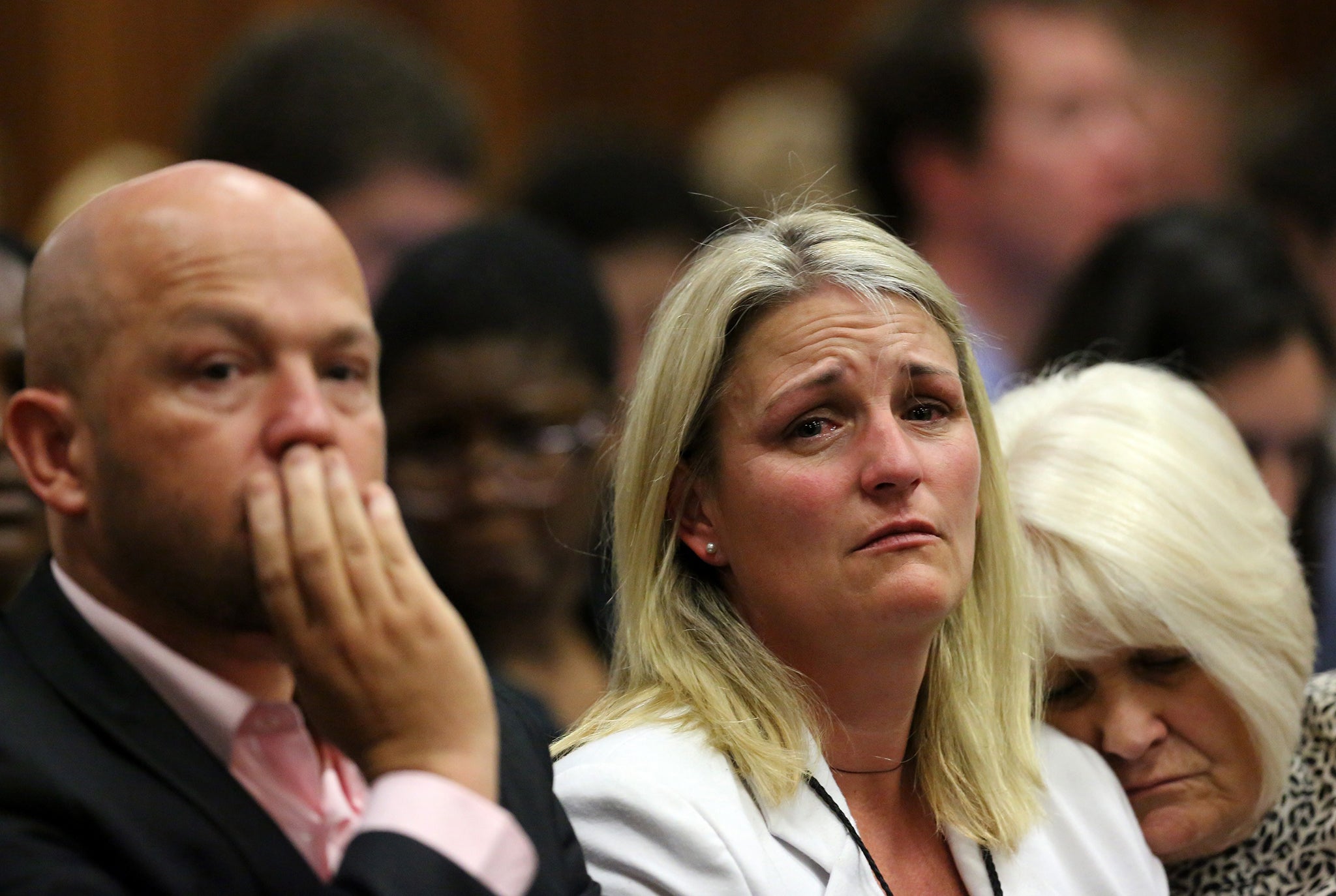 Family members of Reeva Steenkamp react as they listen to the verdict of Oscar Pistorius at the high court in Pretoria