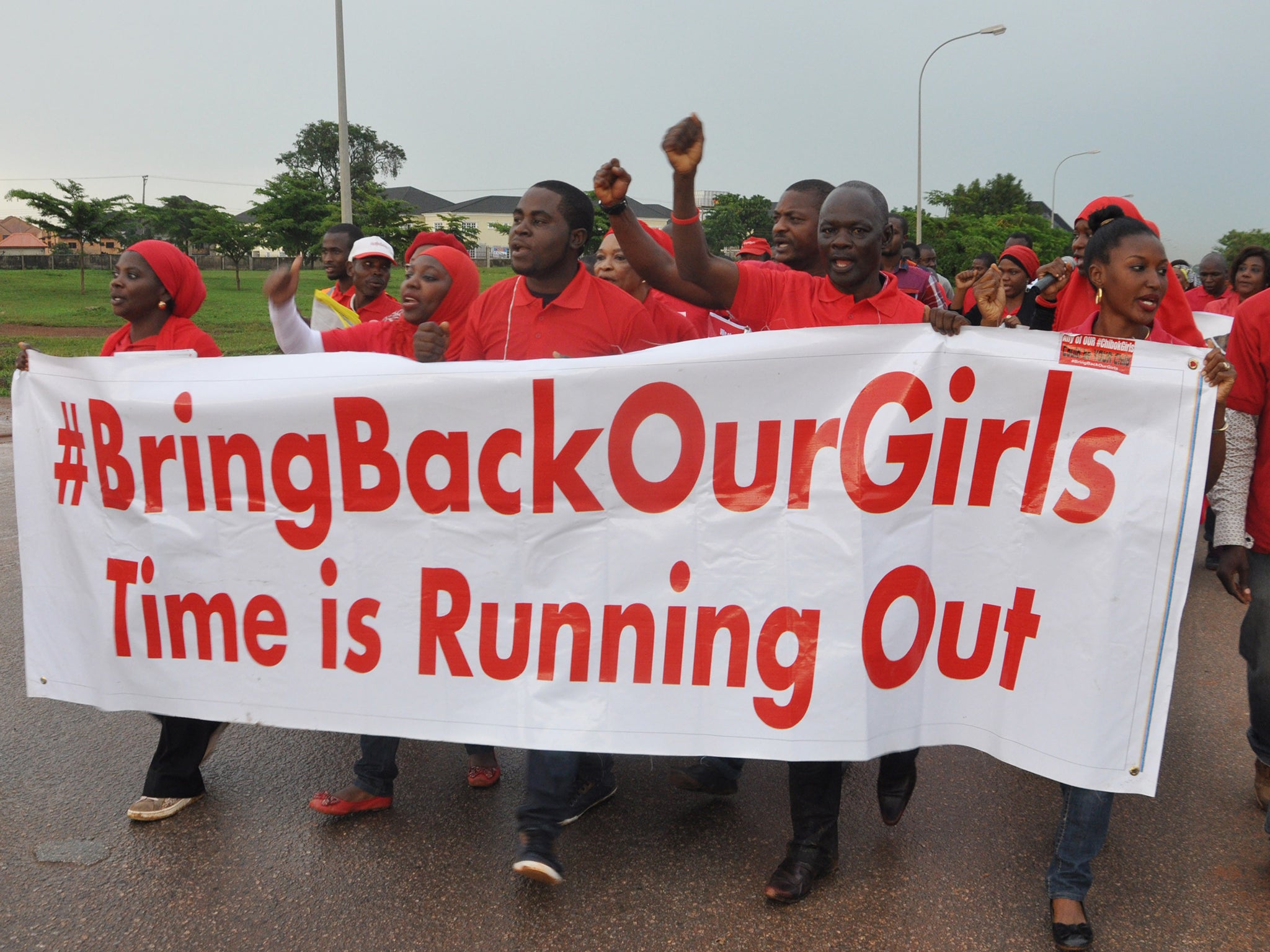 People shout slogans and hold a banner during a demonstration in Abuja, Nigeria. The girls kidnapped by Boko Haram are still missing