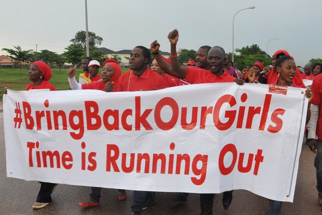 People shout slogans and hold a banner during a demonstration in Abuja, Nigeria. The girls kidnapped by Boko Haram are still missing