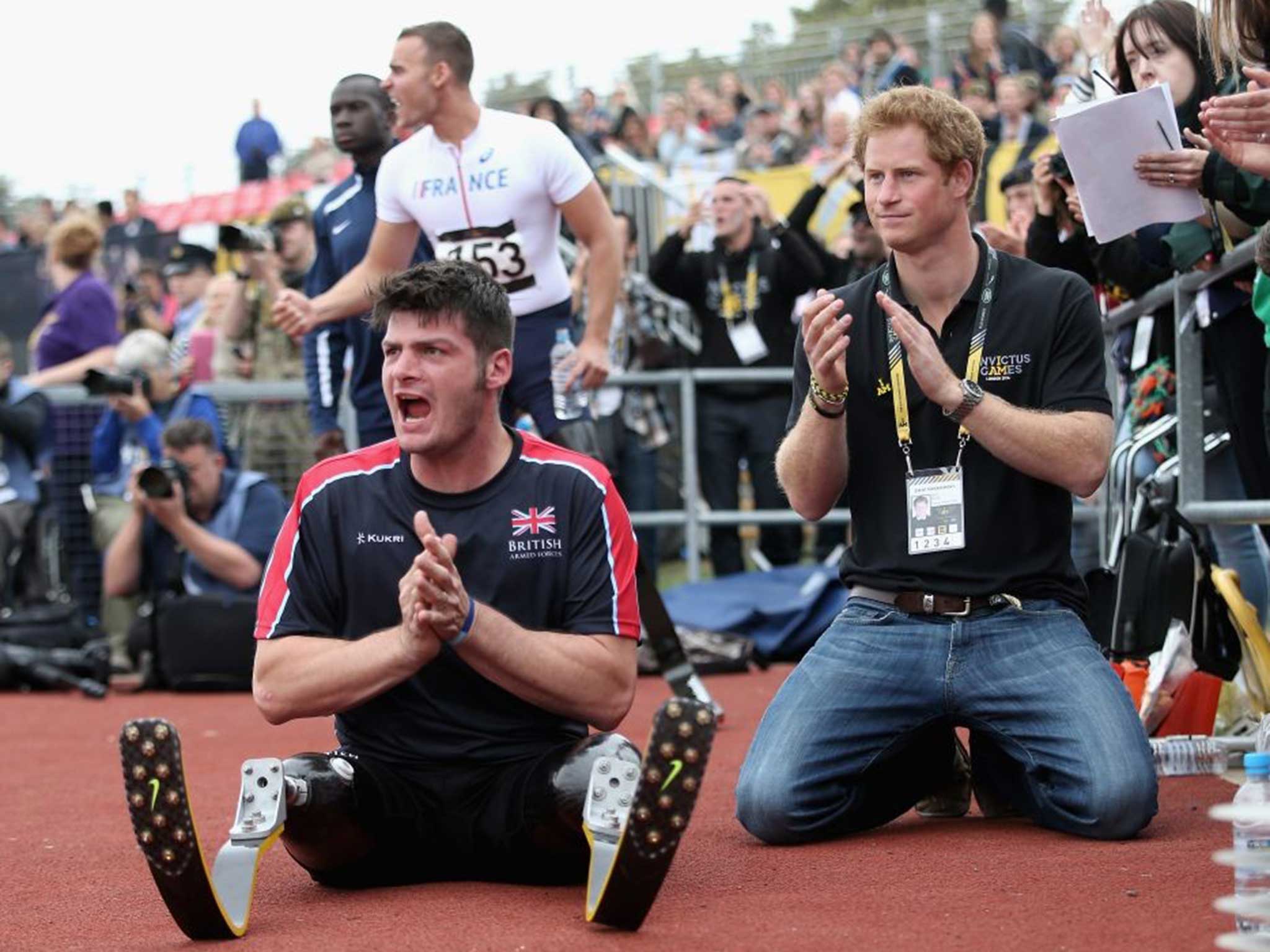 Prince Harry and British Invictus Captain Dave Henson cheer the athletes during the Invictus Games