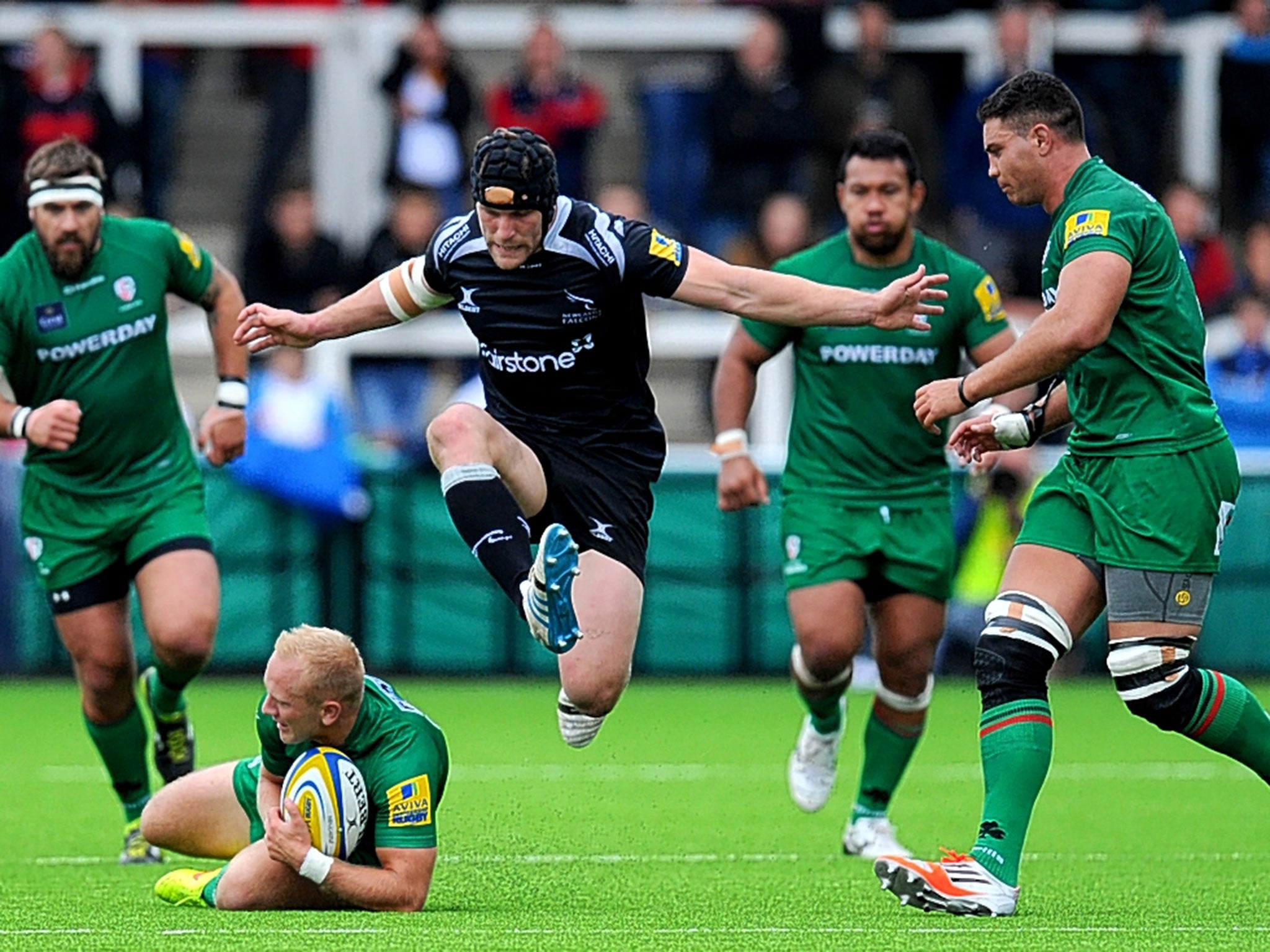 Shane Geraghty of London Irish reacts first to a loose ball as Newcastle Falcons’ Mark Wilson is forced to take evasive action