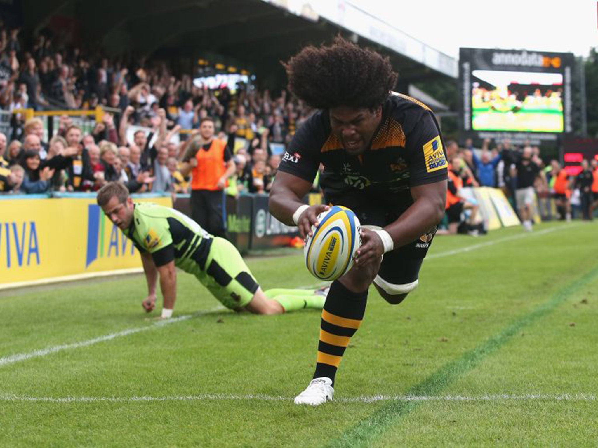Ashley Johnson breaks away from Stephen Myler to score Wasps’ first try against Northampton