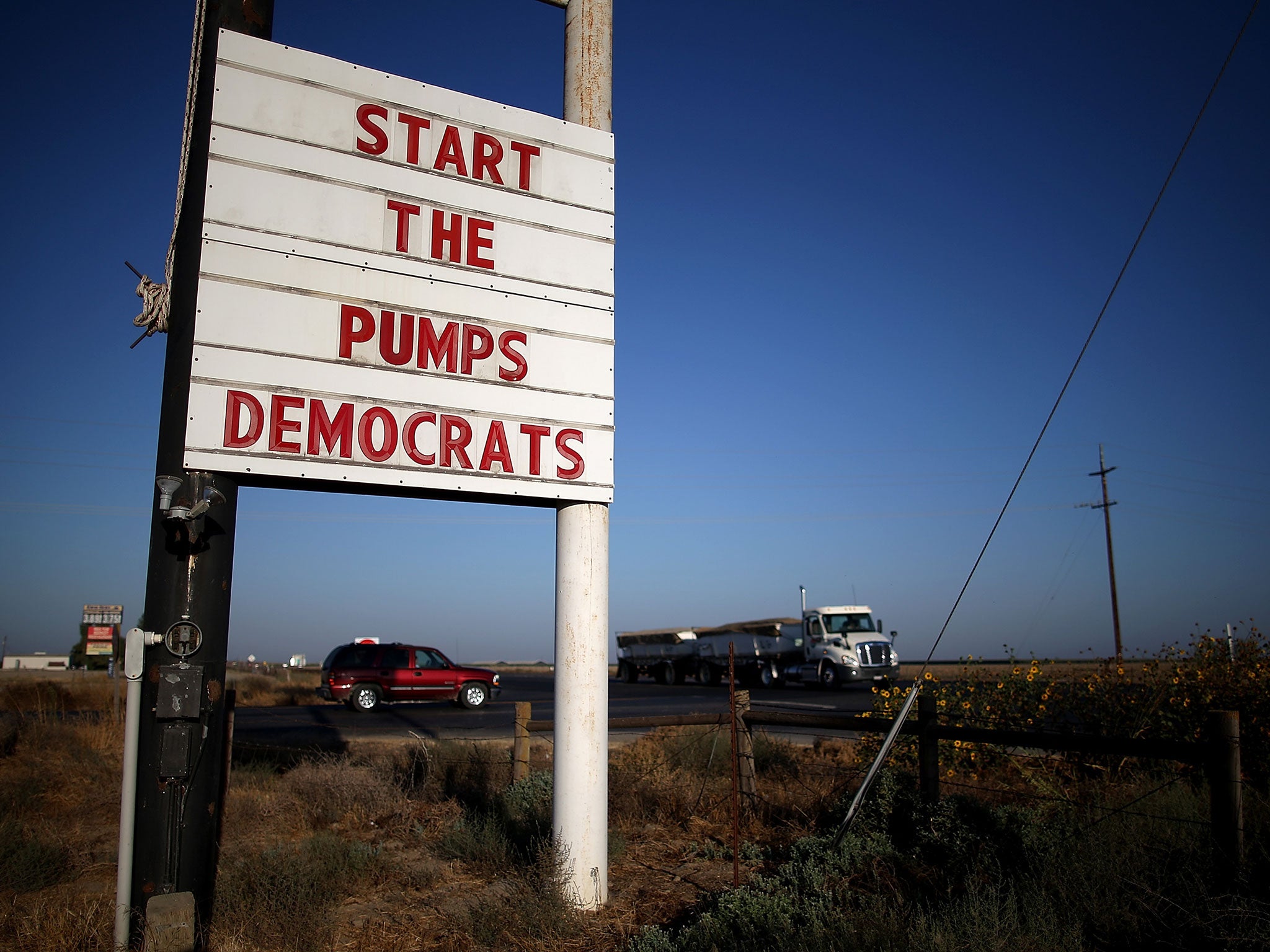 A sign asking politicians to help with the drought in California, where reservoirs are at record low levels and many fields have been left unplanted
