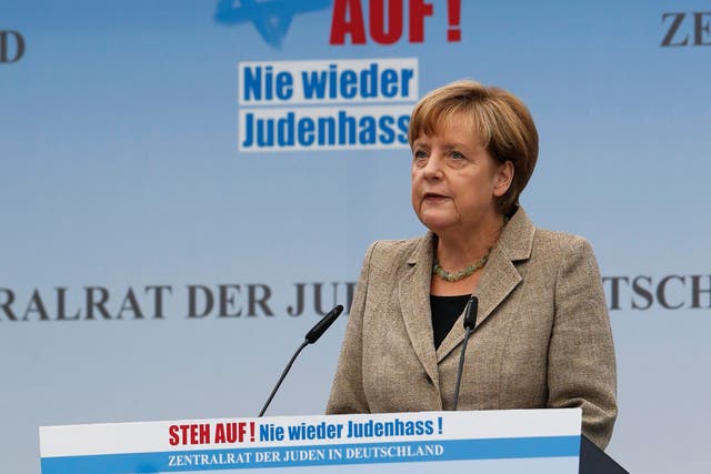 German Chancellor Angela Merkel addresses the anti-Semitism rally in Berlin