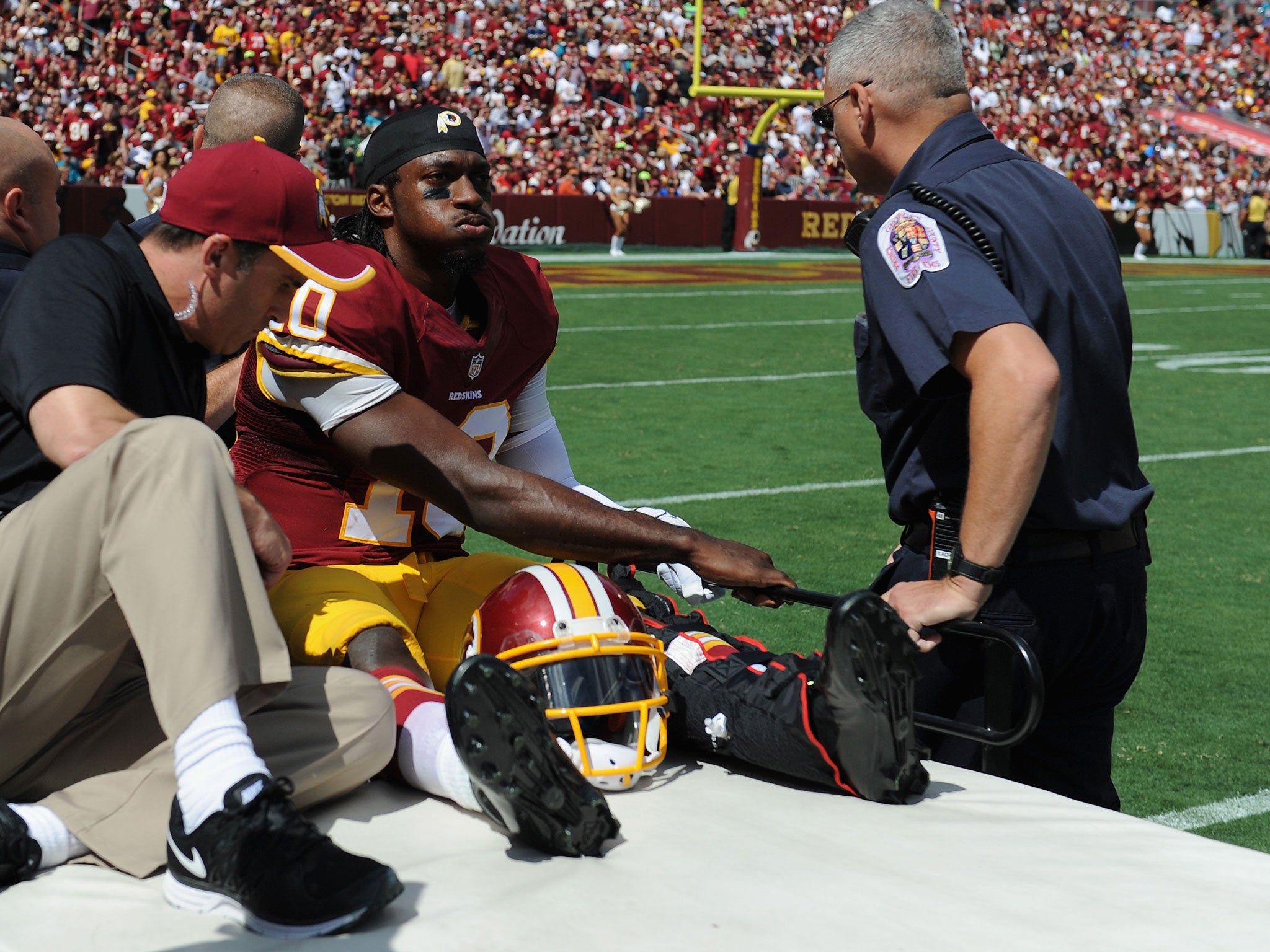 Robert Griffin III is carted off the field after suffering a dislocated ankle