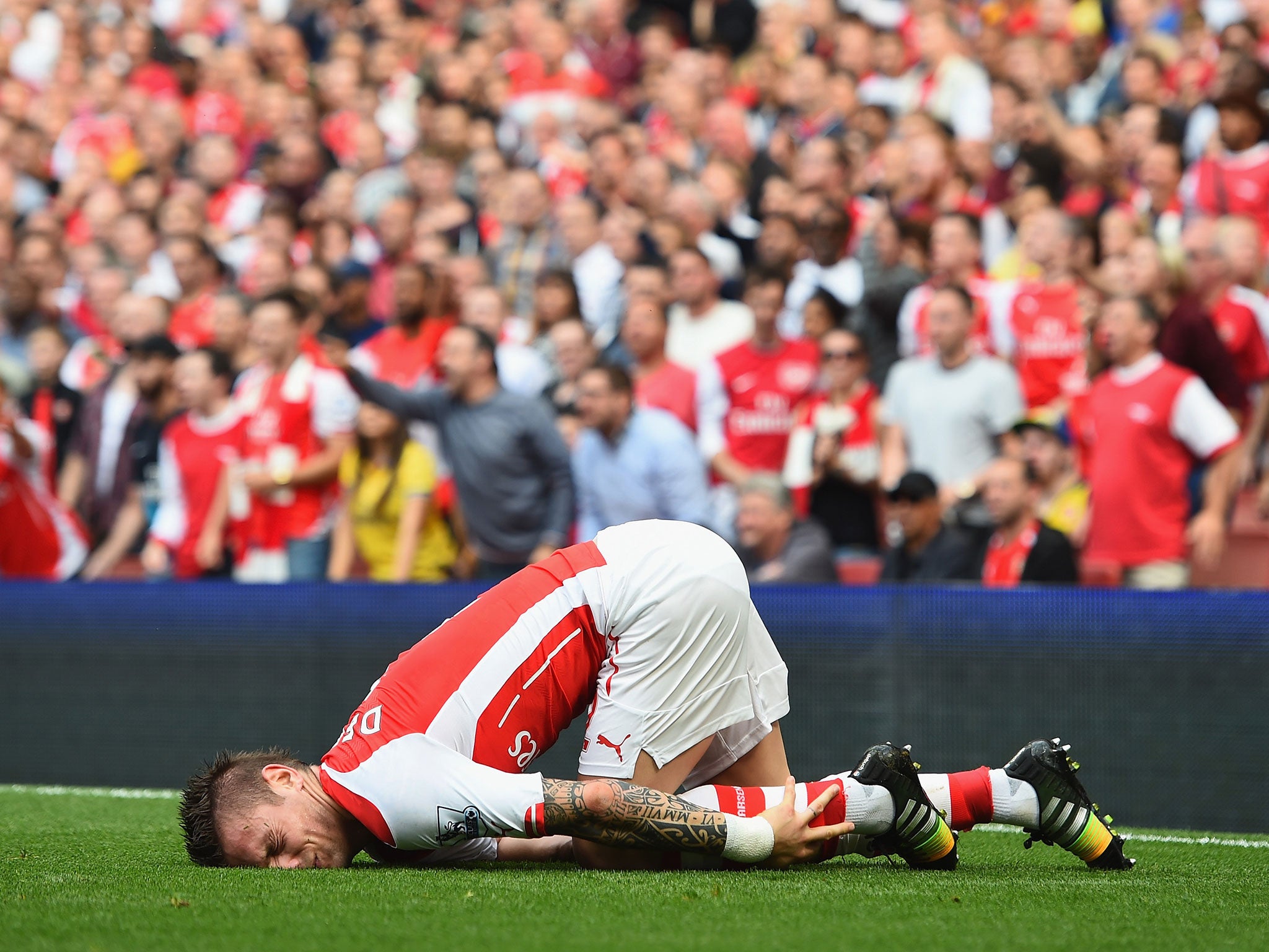 Mathieu Debuchy goes down with an ankle injury during Arsenal's 2-2 draw with Manchester City in September