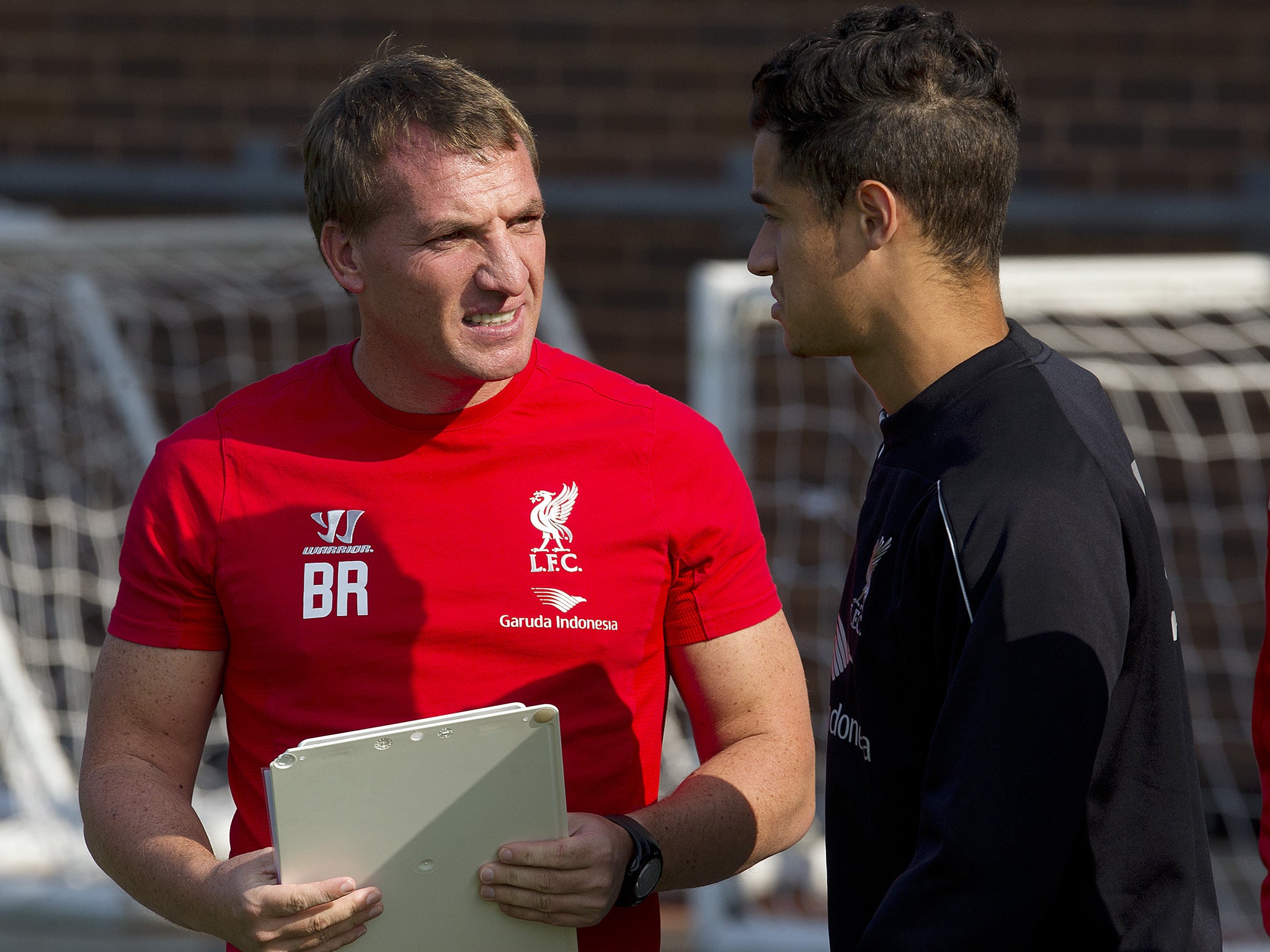 Brendan Rodgers talks with Coutinho