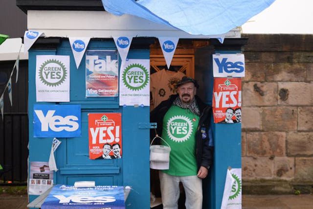 Frank Titterton gives out leaflets from an old police box on Leith Road in Edinburgh ahead of the Scottish referendum