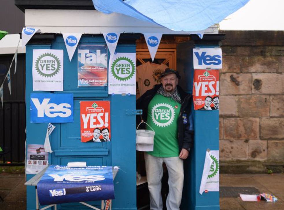 Frank Titterton gives out leaflets from an old police box on Leith Road in Edinburgh ahead of the Scottish referendum