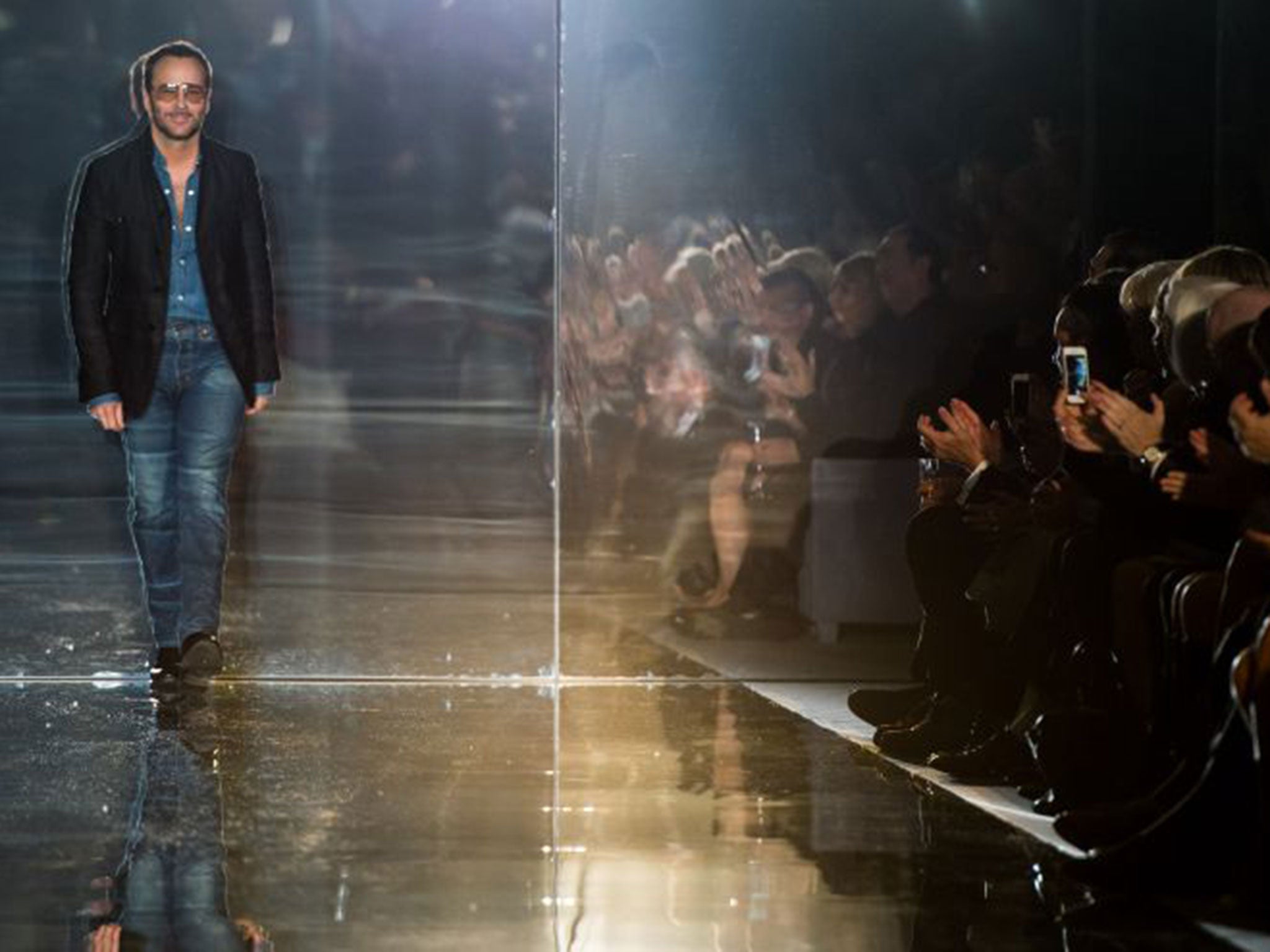 Designer Tom Ford appears on the runway after his TOM FORD show during London Fashion Week