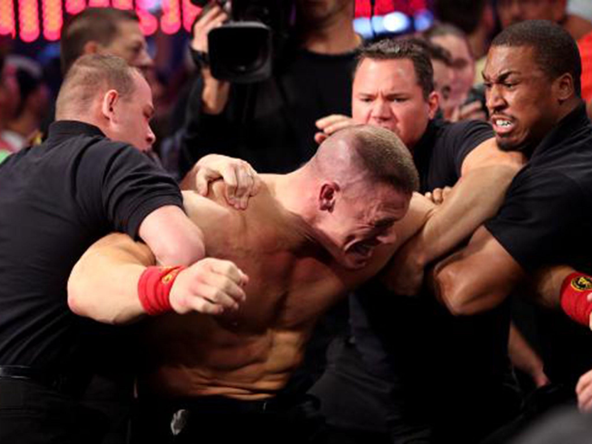Security guards restrain John Cena