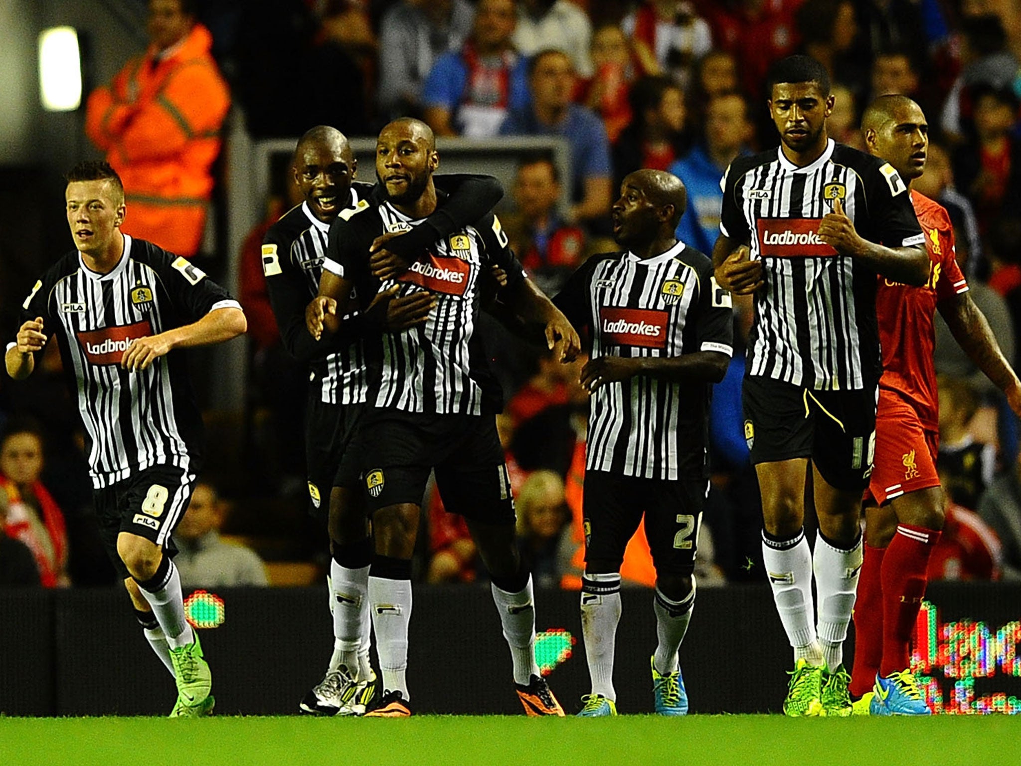 Notts County players celebrate a goal against Liverpool in the 2013-14 League Cup