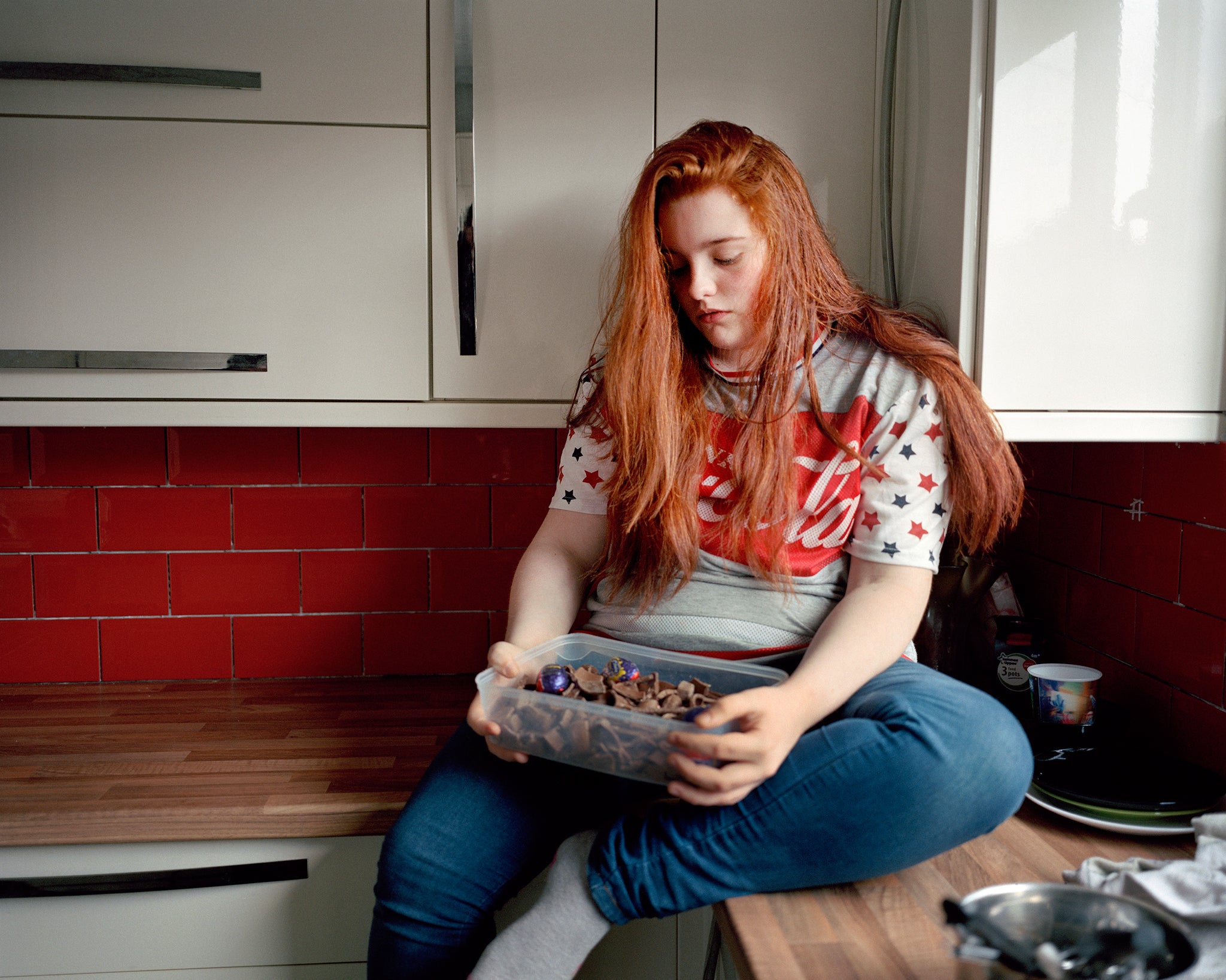 Deena, age 12, looks at her Easter Chocolate at her home in Port Talbot, Wales. From the series, The Big O: an intimate study of the young people behind the childhood obesity statistics