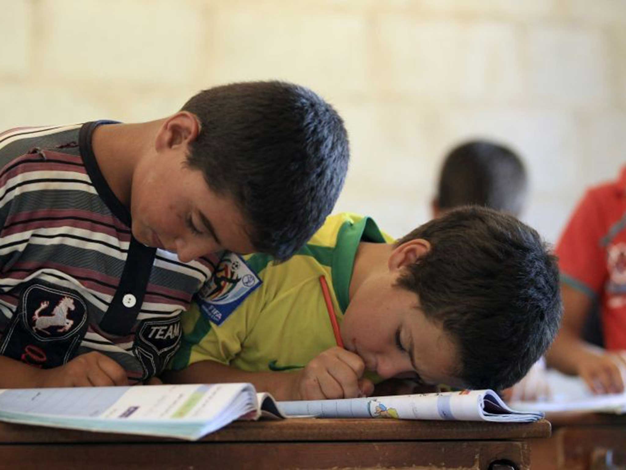 Children attend a class during the first day of school in Idlib countryside earlier this month