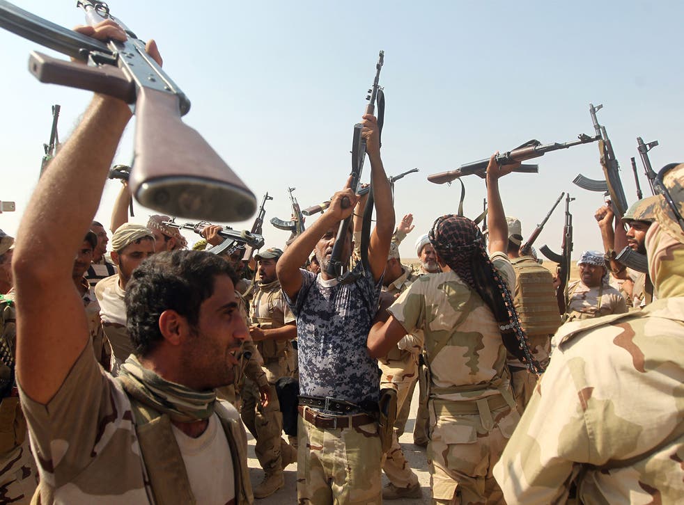 Iraqi volunteer fighters celebrate the breaking of the jihadist siege on the Shiite town of Amerli on September 1, 2014