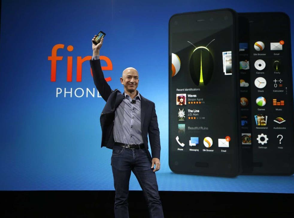 Jeff Bezos poses next to Fire phone