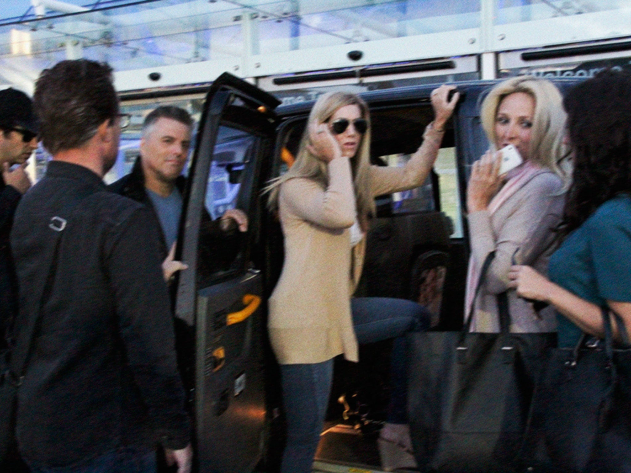 The friends jump in a black cab