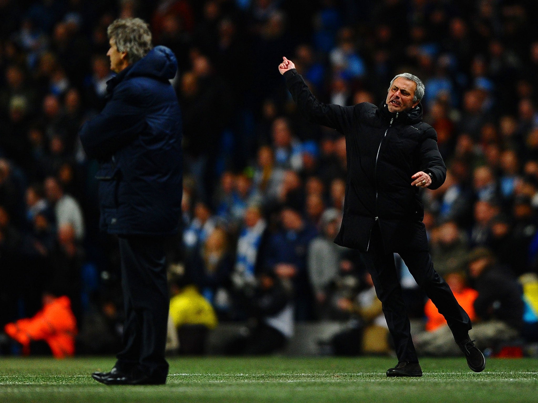 Manuel Pellegrini manager of Manchester City looks on as Jose Mourinho manager of Chelsea reacts during the Barclays Premier League match between Manchester City and Chelsea at Etihad Stadium on February 3, 2014.