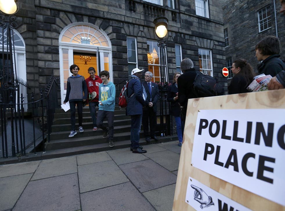 Young voters leave a polling station in Charlotte Square, Edinburgh