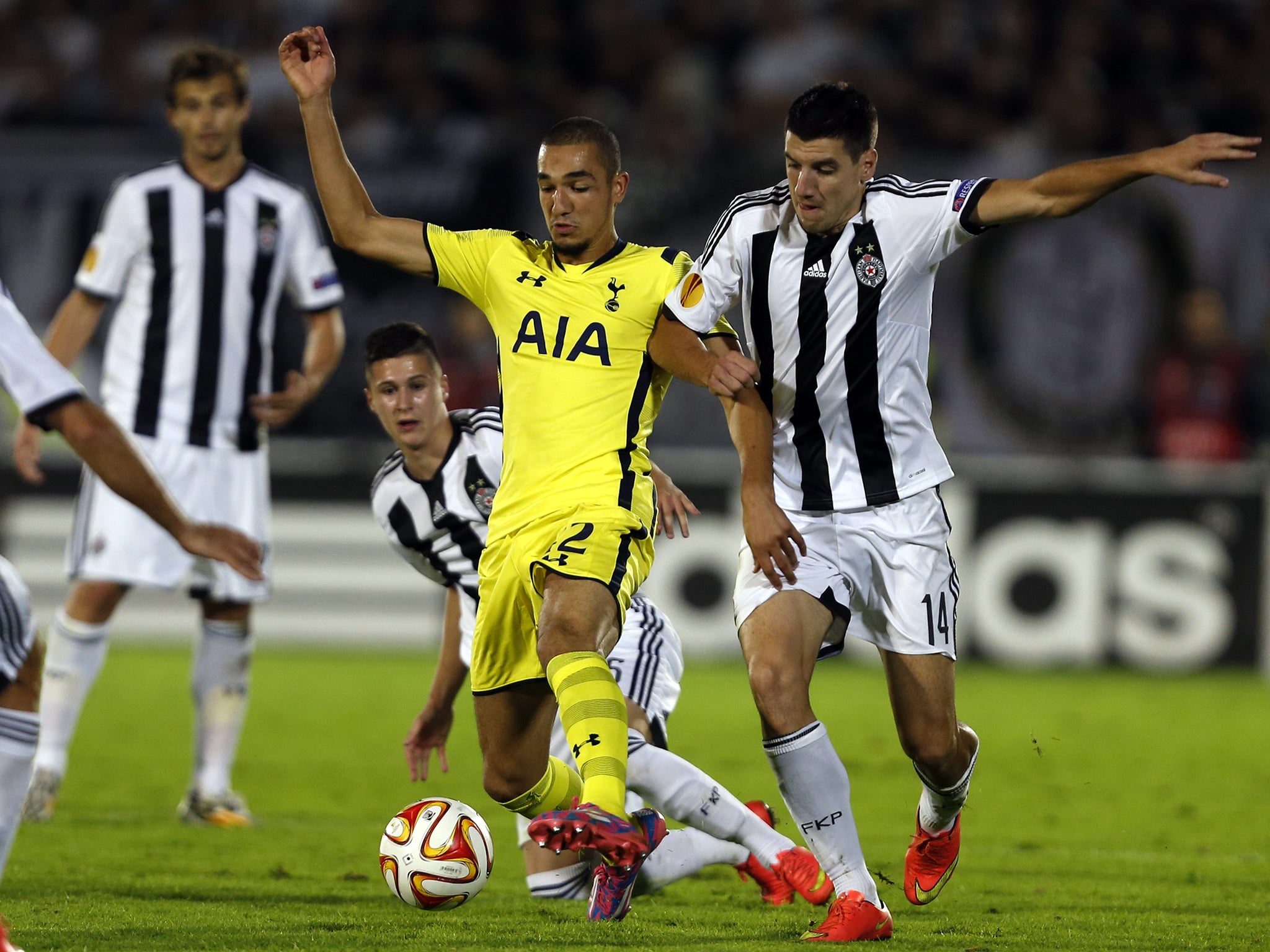 Tottenham Hotspur's Nabil Bentaleb (center) and Partizan Belgrade's Petar Grbic challenge for the ball