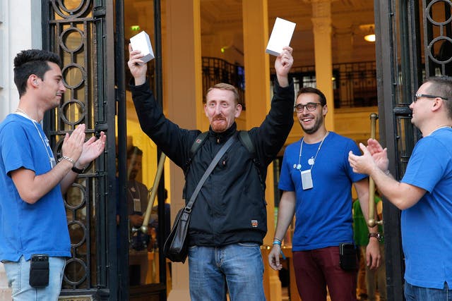 Customer Sylvain leaves an Apple store with boxes as the new iPhone 6 goes on sale in Paris 