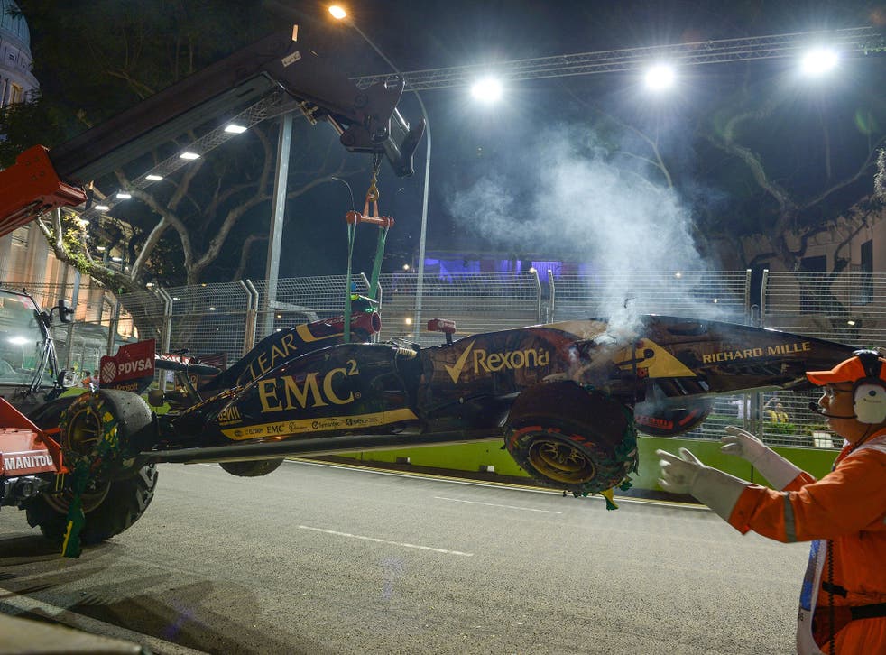 Pastor Maldonado's wrecked Lotus is retrieved after he brought out the red flag in second practice