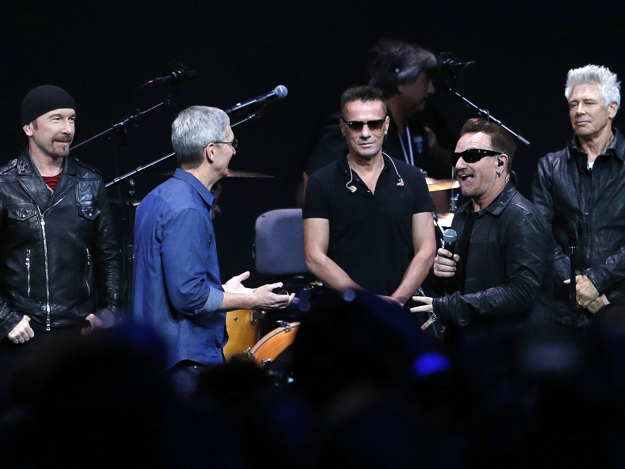 Apple chief Tim Cook (in blue shirt) with (from left) The Edge, Larry Mullen Jr, Bono
and Adam Clayton of U2 at the iPhone 6 launch