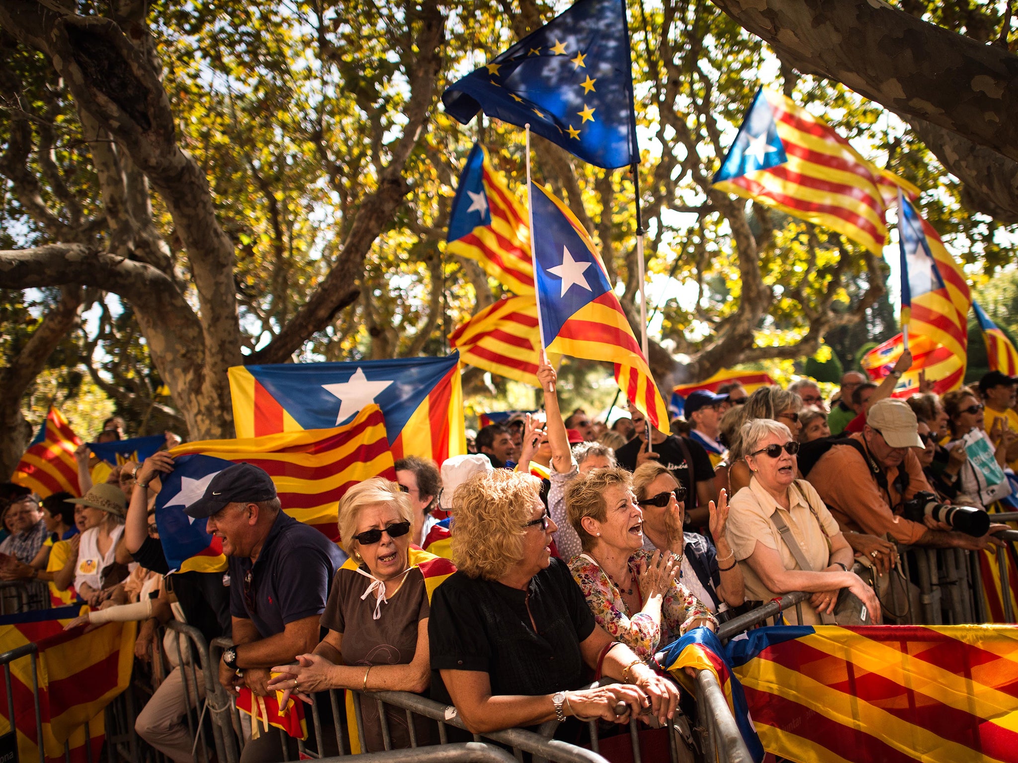 Pro-independence demonstrators shout slogans outside the Catalan Parliament