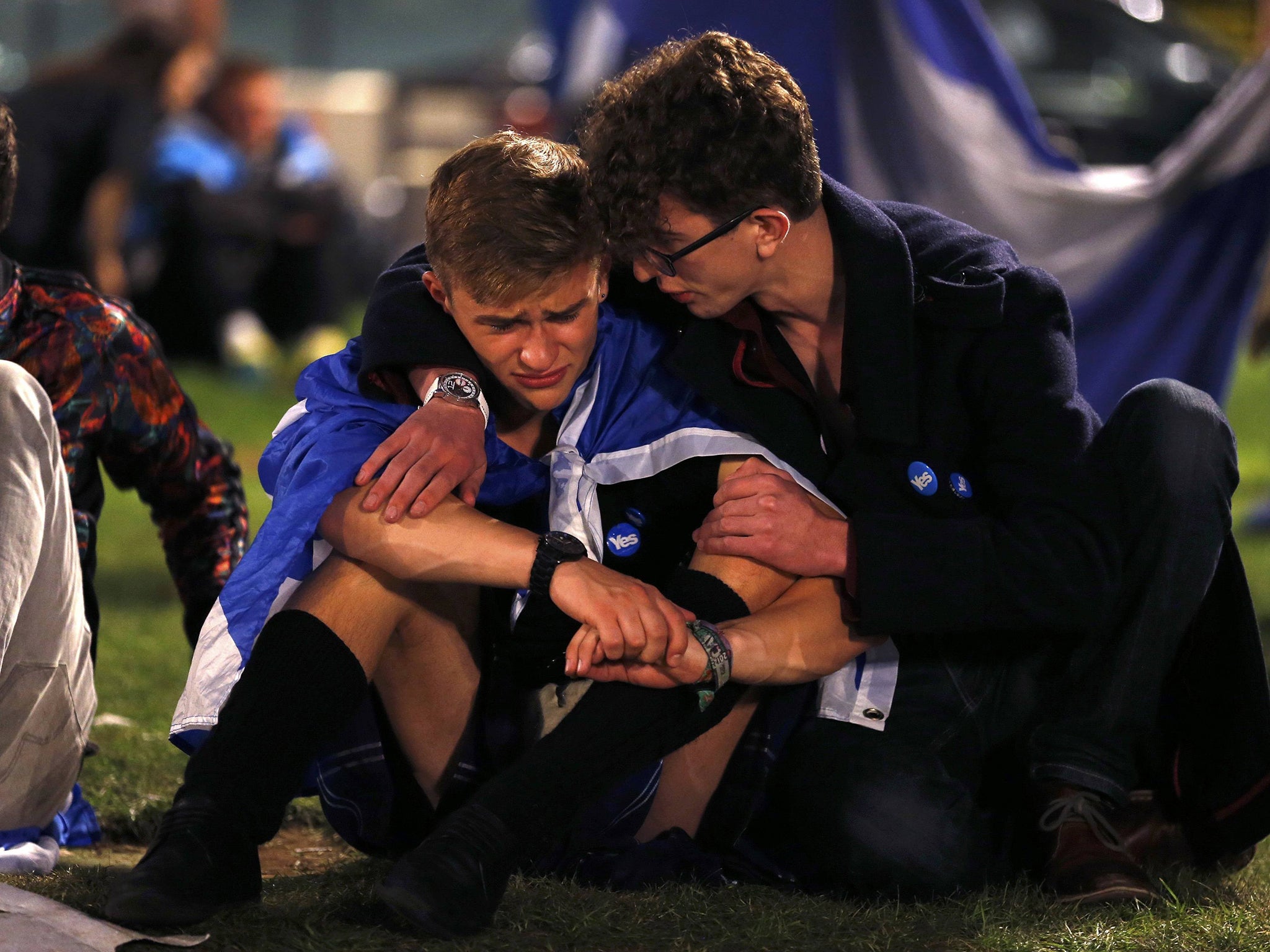 Dejected supporters from the "Yes" Campaign react as they sit in George Square in Glasgow