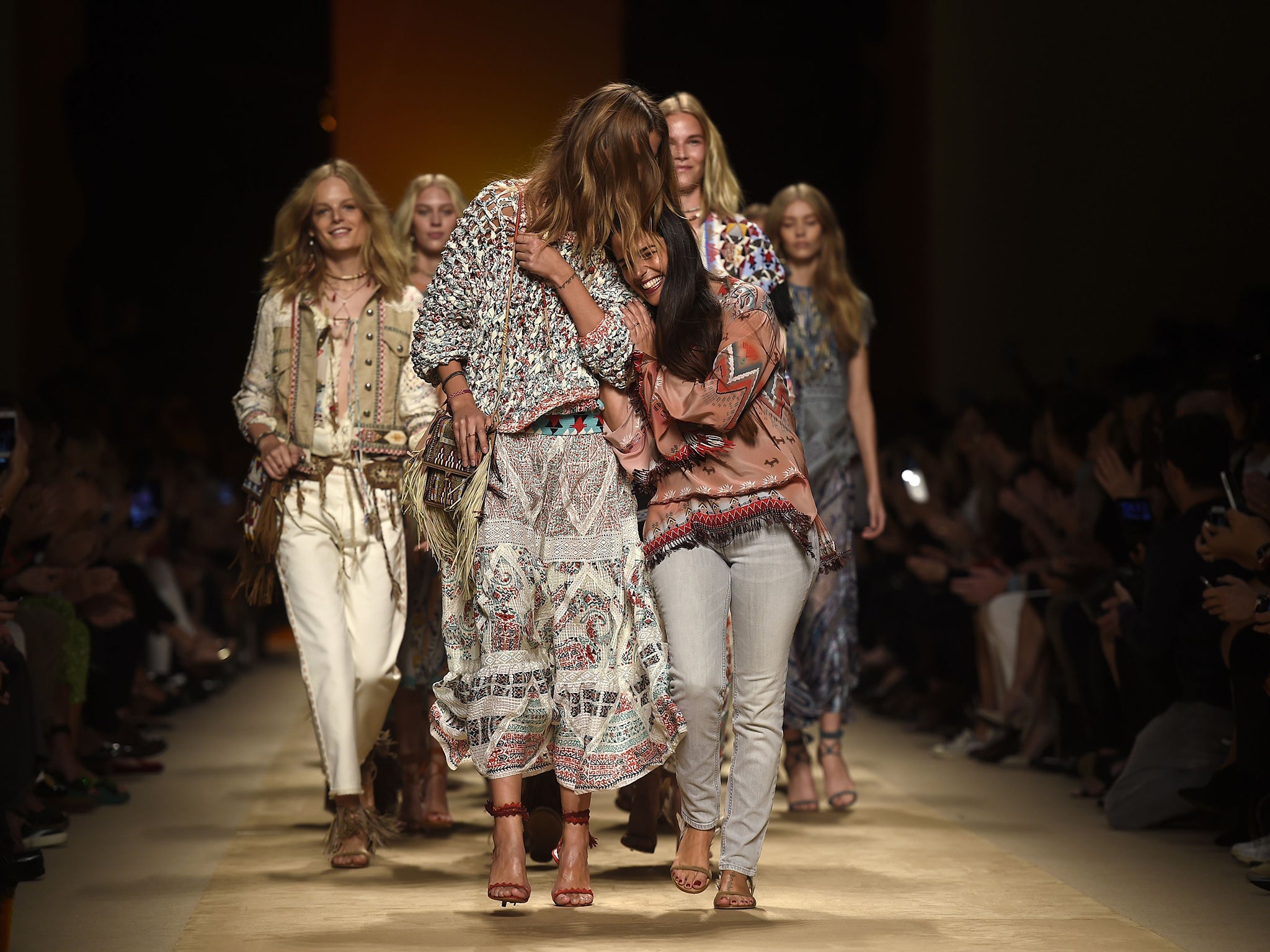 The designer Veronica Etro (right) and her models enjoy the closing moments of her show during the 2015 spring/summer collections at Milan Fashion Week
