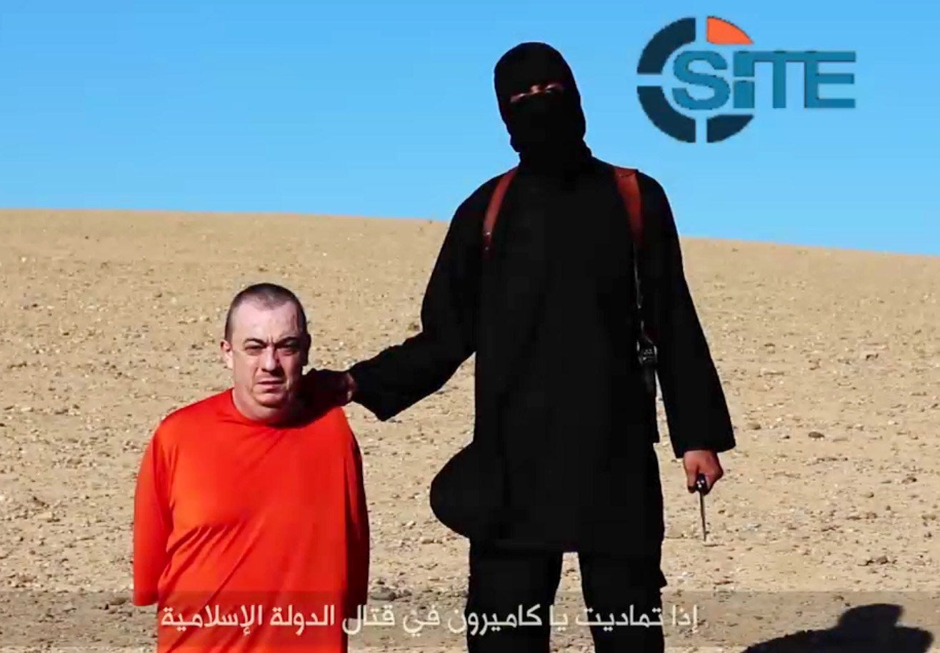 An image grab taken from a video released by the Islamic State (Isis) showing s a masked militant threatening to execute British hostage Alan Henning