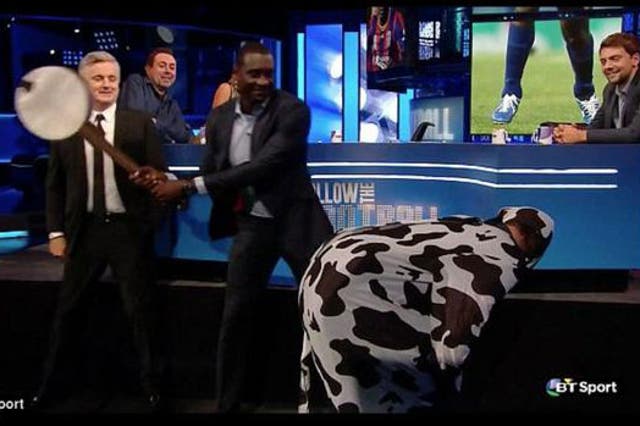 Emile Heskey hits a cow's backside with a banjo